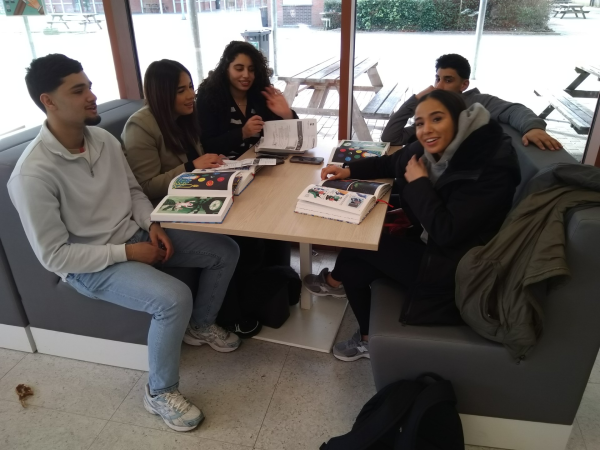Leerlingen rond de tafel in de Spectrumschool, op tafel 'De Bondgenoten' van Brecht Evens